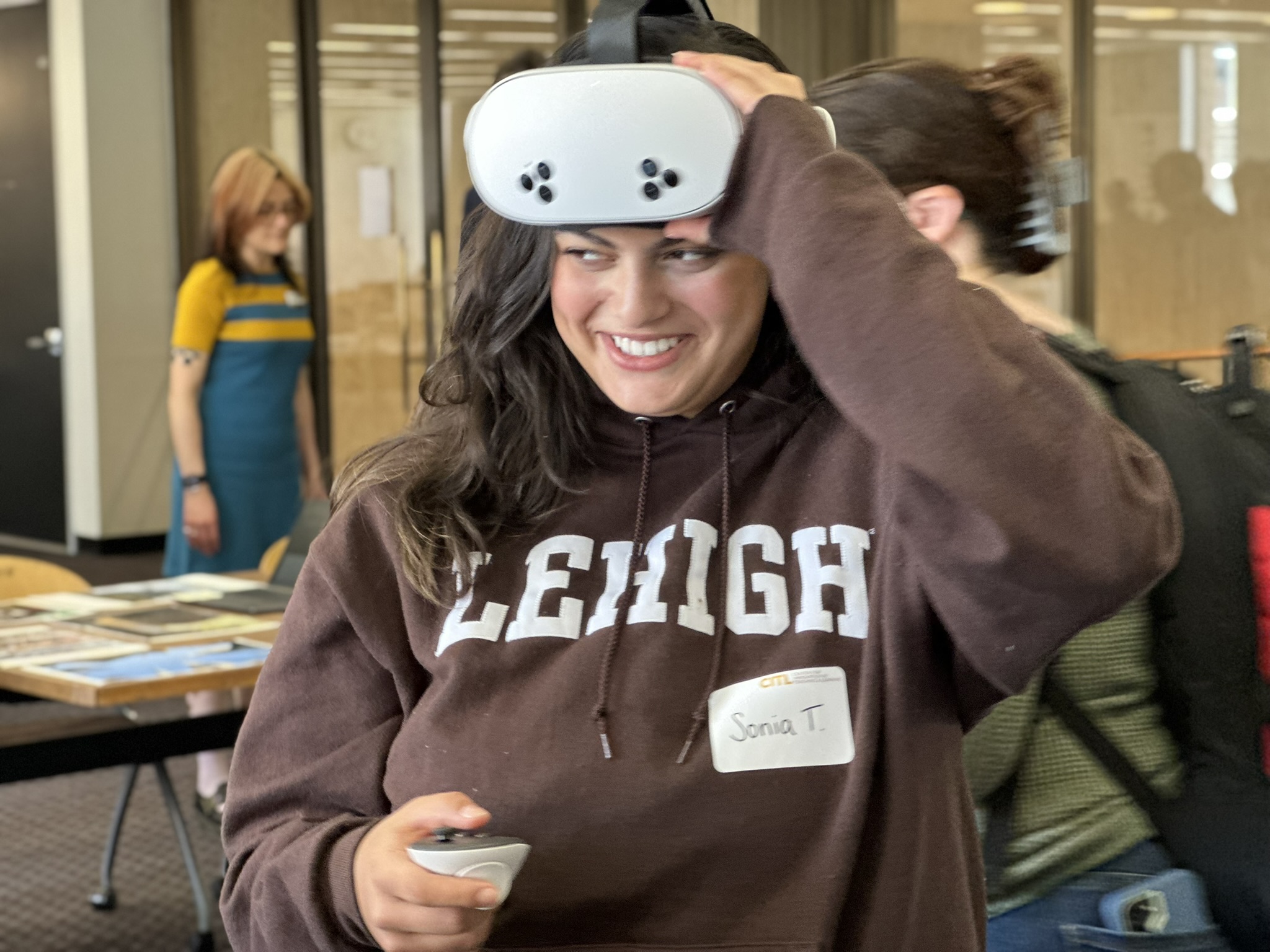 student wearing VR headset and holding hand controls