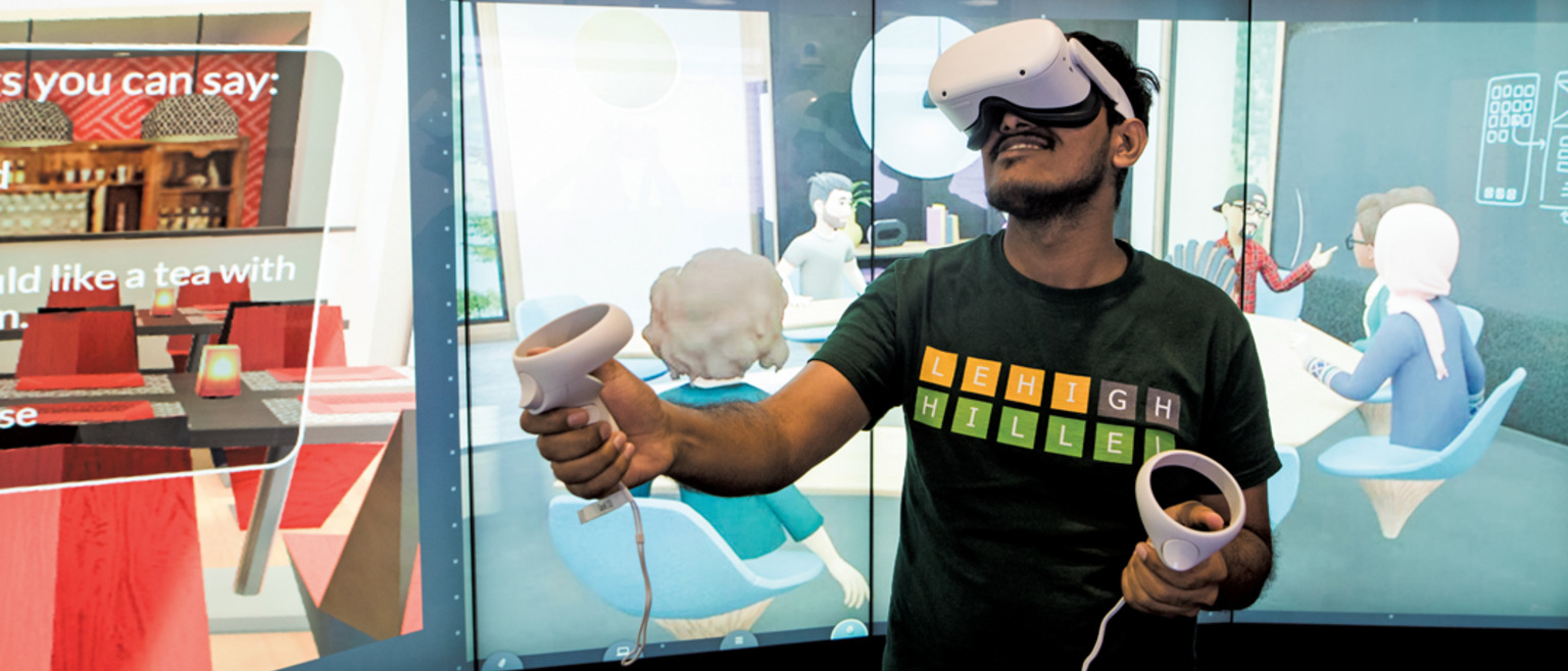 Student with a headset and controllers with an image on the display behind them.