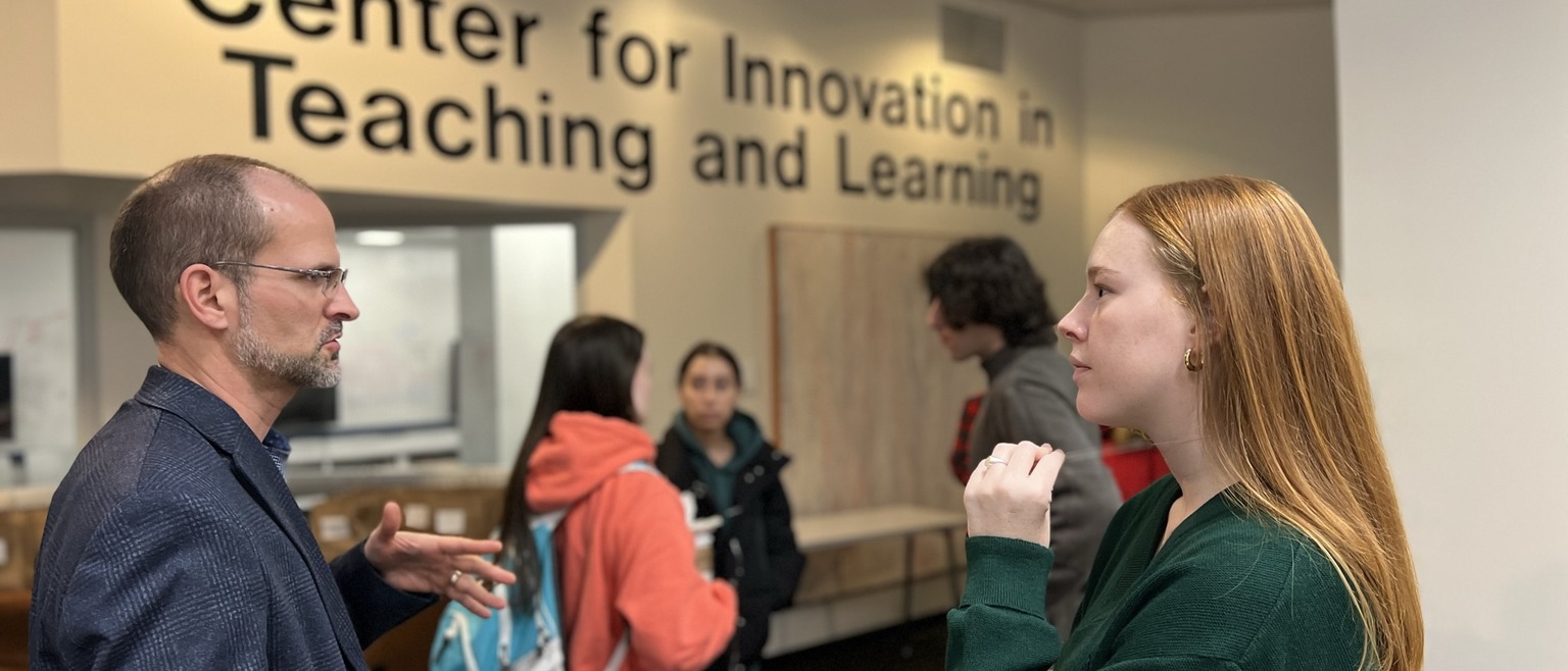 photo of a faculty member and a student talking